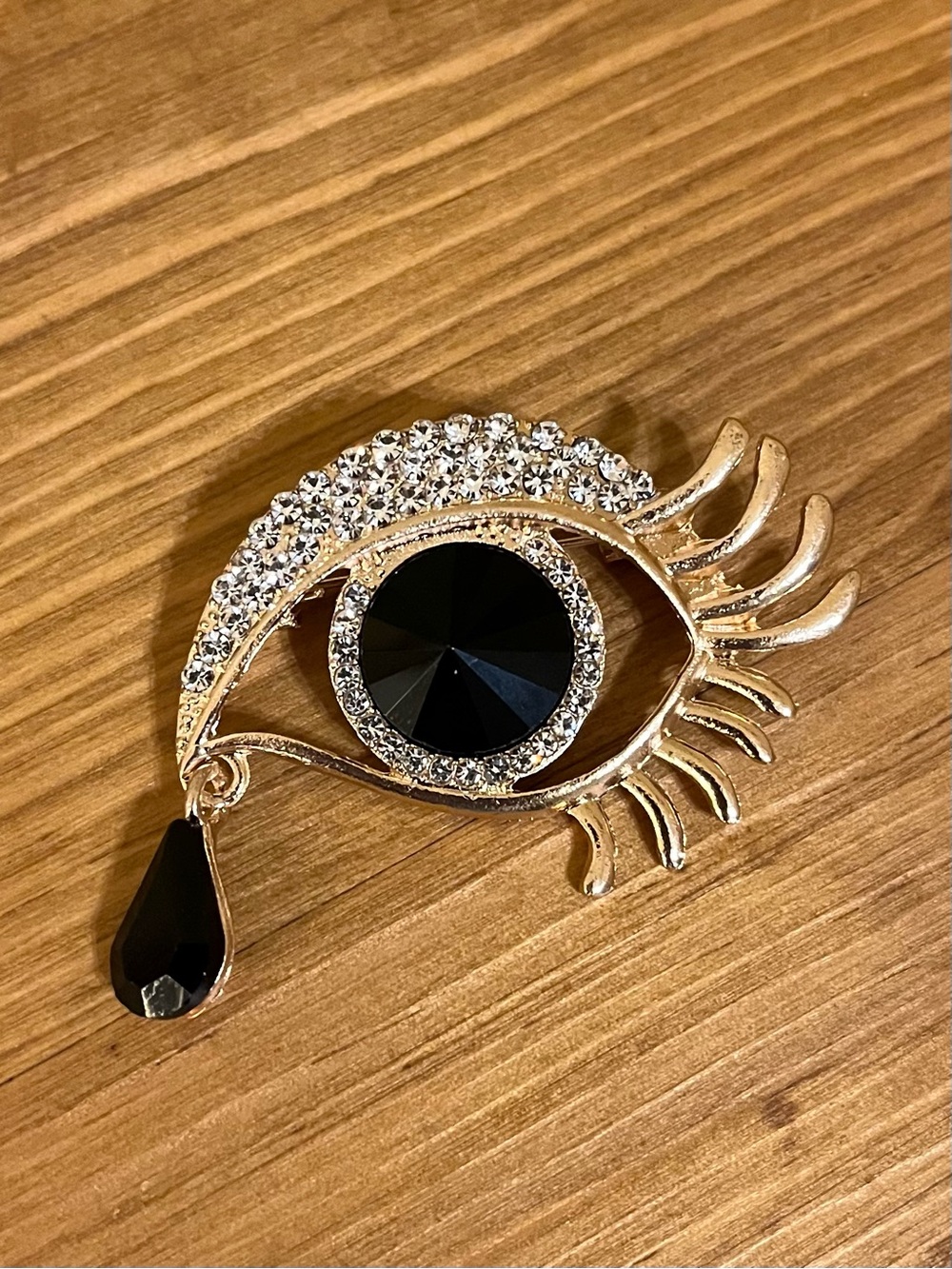 Black eye ball brooch with dangle black tear drop & rhinestones on gold tone 2”